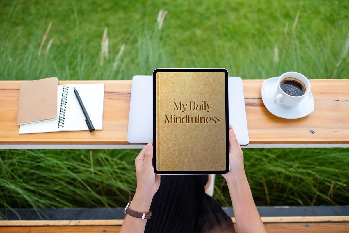 top view A woman holding a tablet with daily mindfulness journal